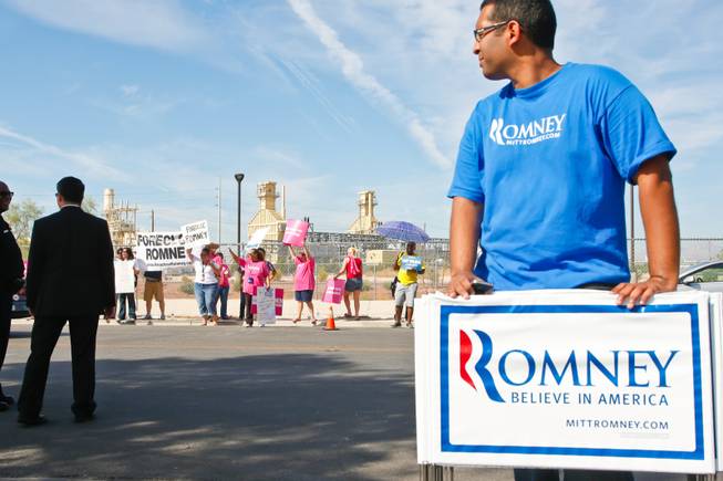 Obama supporters gather outside a North Las Vegas business Sierra Truck Body & Equipment, where presidential hopeful Mitt Romney is holding an event, Friday, Aug 3, 2012.